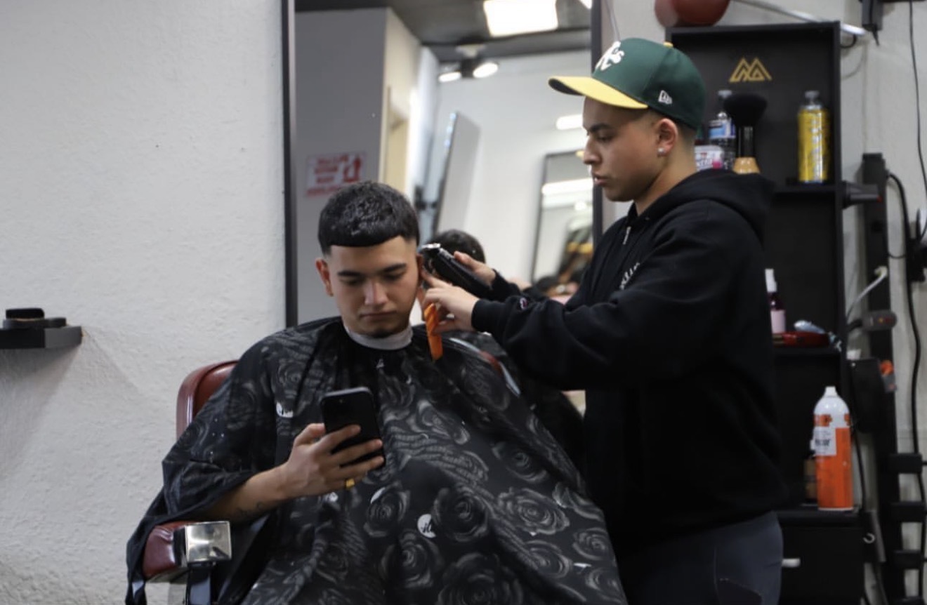Javier Lopez cutting hair at Sharp Society Barbershop Richmond CA